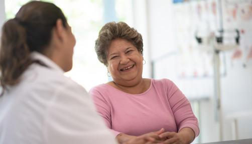 Older Woman talking with the Doctor laughing