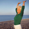 Old caucasian woman exercising outdoors to stay fit