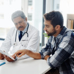 Cropped shot of a mature male doctor and patient having a discussion in the doctor's office before a checkup