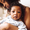 Black mother holding her baby
