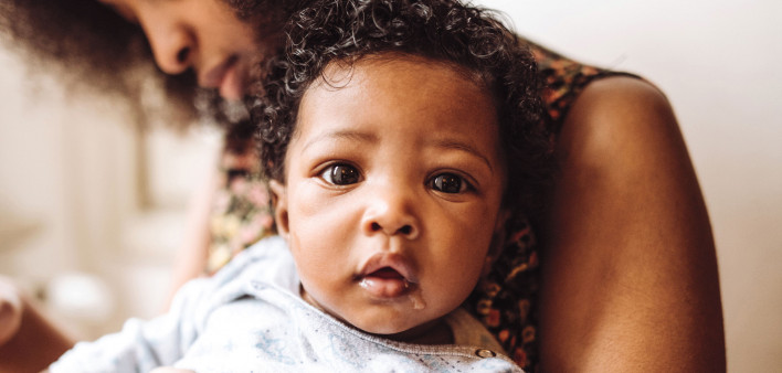 Black mother holding her baby
