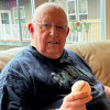 Wayne Lundberg holds a baseball signed by Fred Hutchinson and members of the Rainiers team. The prostate cancer patient and devout sports fan met Hutchinson in 1955 when he was just 12, a memory Lundberg still holds dear.