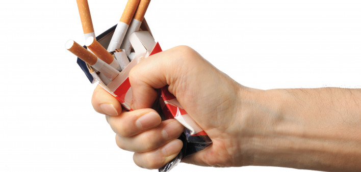 Hand crushing box of cigarettes