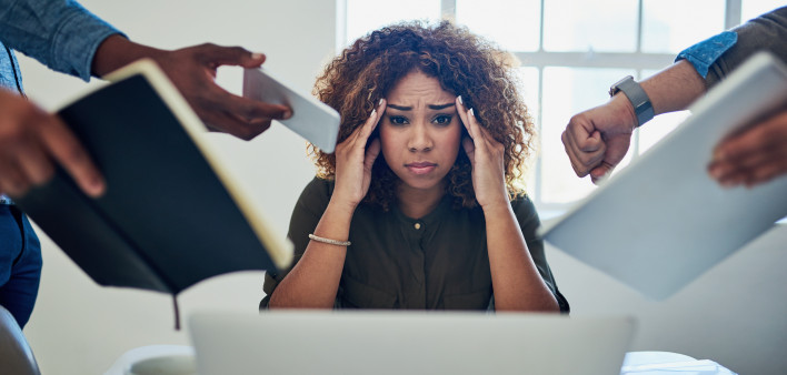 Shot of a stressed out young woman working in a demanding career