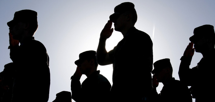 Soldiers Salute the Flag at Sunset