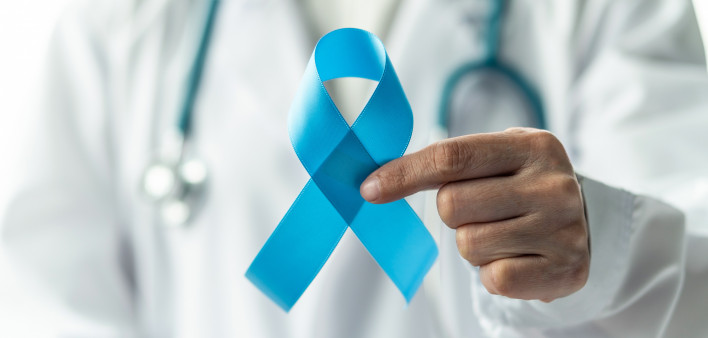 doctor in white lab coat hold blue ribbon prostate cancer awareness