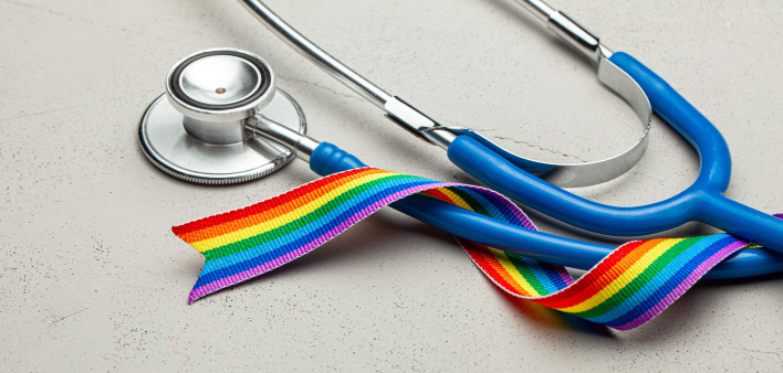 Stethoscope and LGBT rainbow ribbon pride tape symbol. Medical support after sex reassignment surgery.