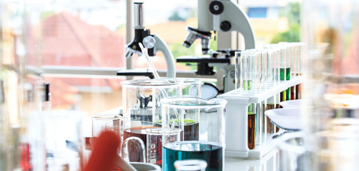 beakers and microscopes in laboratory