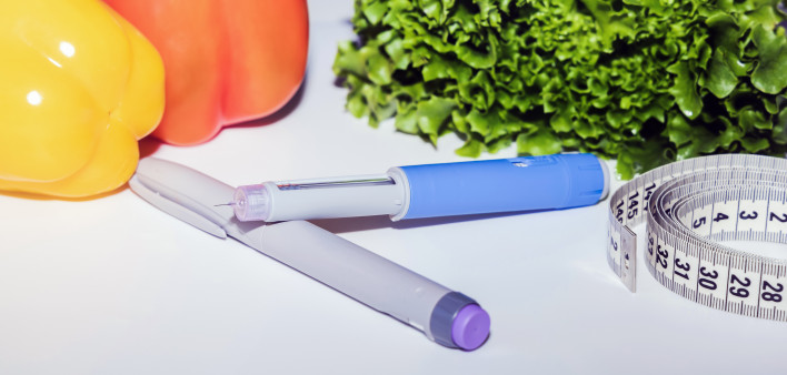 Insulin injection pen or insulin cartridge pen for diabetics. Medical equipment for diabetes parients. Woman holding an injection pen for diabetic.