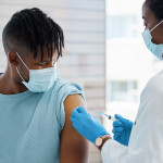 Young man being given an injection vaccine