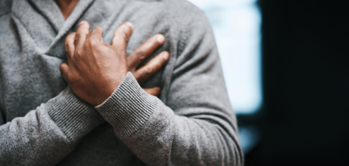 African American Man holding chest pain heart