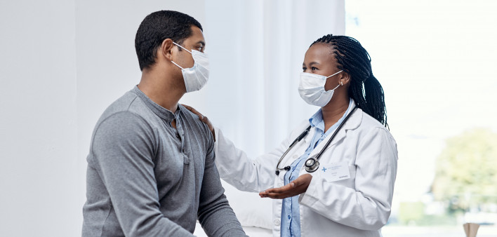 black doctor taklking to latin patient