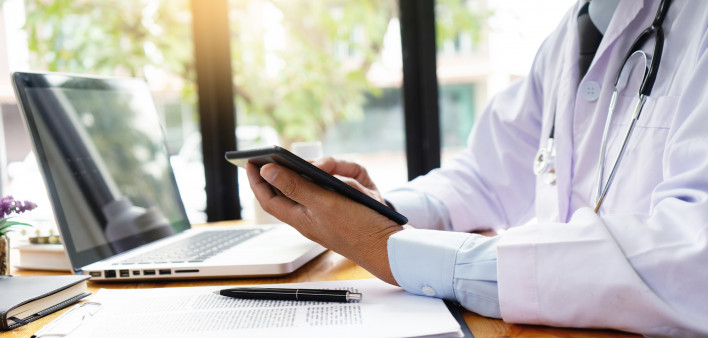professional doctor use computer and tablet