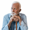 elderly man sitting leaning on his cane