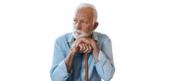 elderly man sitting leaning on his cane