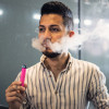 Young latino man e-cigarette smoking