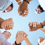 group of people holding hand to form a circle support