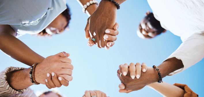 group of people holding hand to form a circle support