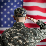 Military US Soldier Saluting Flag. Army Veteran