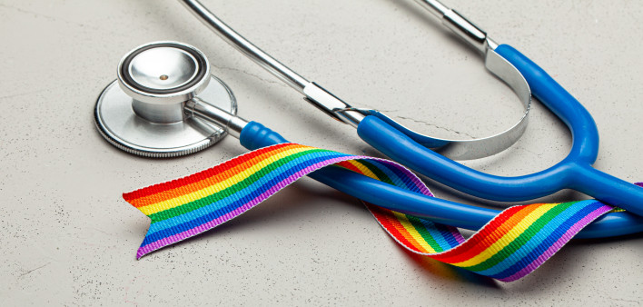 Stethoscope and LGBT rainbow ribbon pride tape symbol. Medical support after sex reassignment surgery.