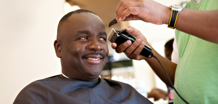 African American Barber Shop Smile man getting hair cut