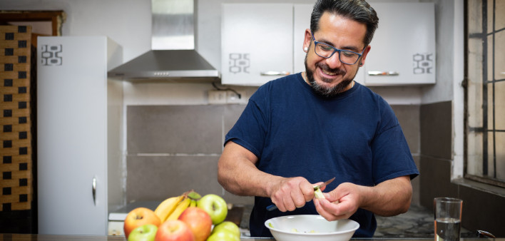 A healthy Latino man living with HIV in the kitchen