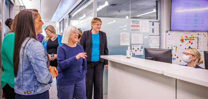 U.S. Sen. Patty Murray (center), visits with senior nurse manager Mitch Mitchell (left) and Dr. Nancy Davidson and staff at the nurses’ station during her visit to the Bezos Family Immunotherapy Clinic at Fred Hutch Cancer Center, on June 27, 2024, in Sea