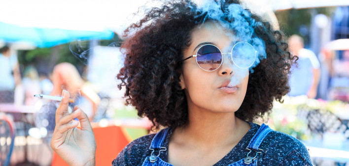 African American woman smoking in cafeteria