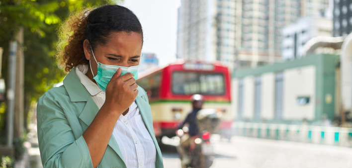 African American women wearing masks face dust Smoke problems on the road in the capital. stock photo City, Coughing, Pollution, Adult, Adults Only