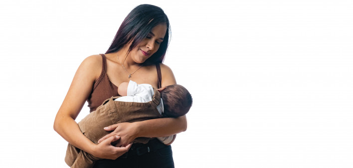 woman nursing her baby holding baby