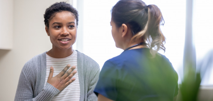Nurse explaining good news to female patient