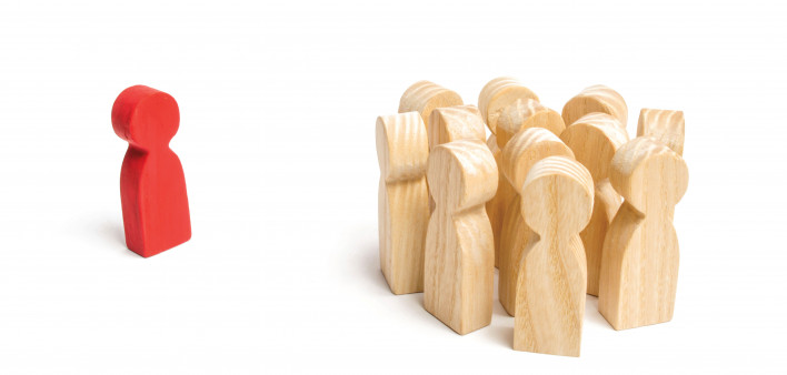 wooden block figures with one red outcast
