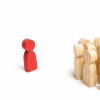 wooden block figures with one red outcast
