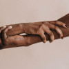 two hands holding each other black