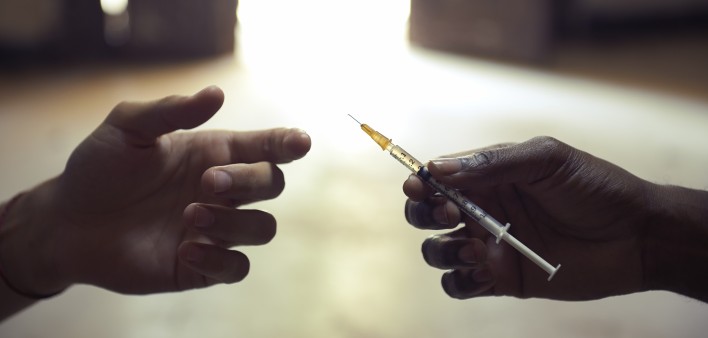 drug users passing a syringe