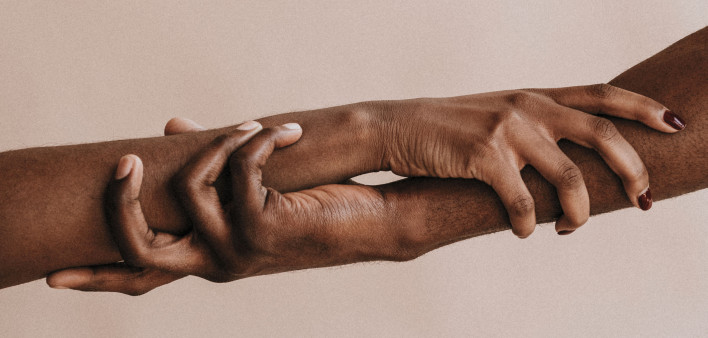 two hands holding each other black