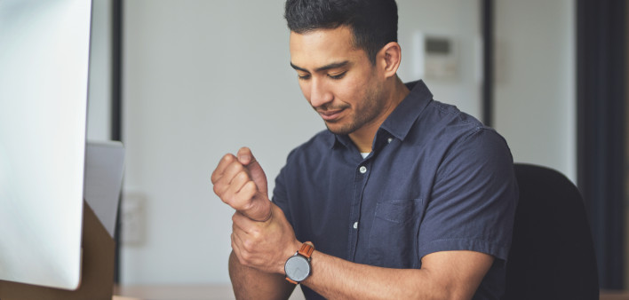 man holding wrist in pain