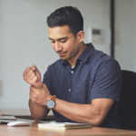 man holding wrist in pain