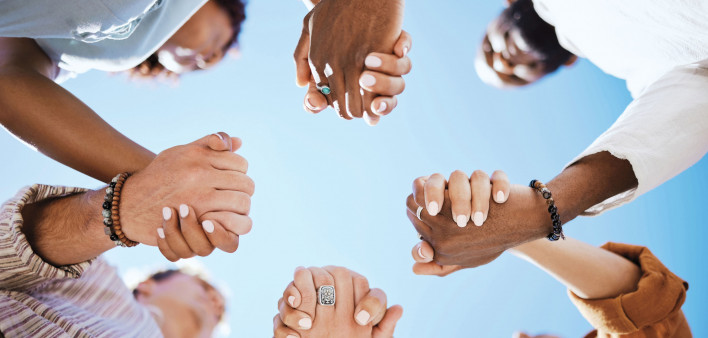 group of people holding hand to form a circle support