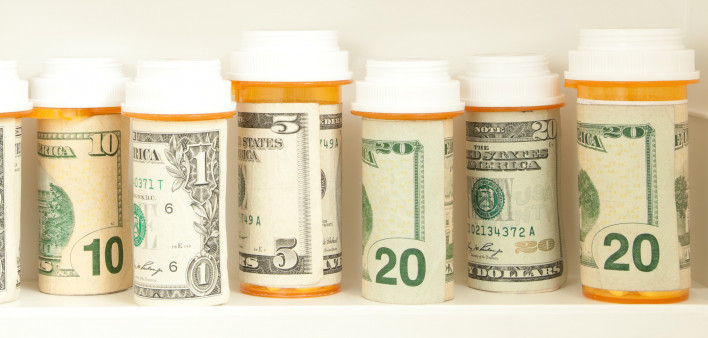 pill bottles with money as labels cost of healthcare