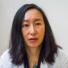 Heather Cheng, MD, PhD, pictured speaking with a prostate cancer patient, heads the Fred Hutch Prostate Cancer Genetics Clinic.