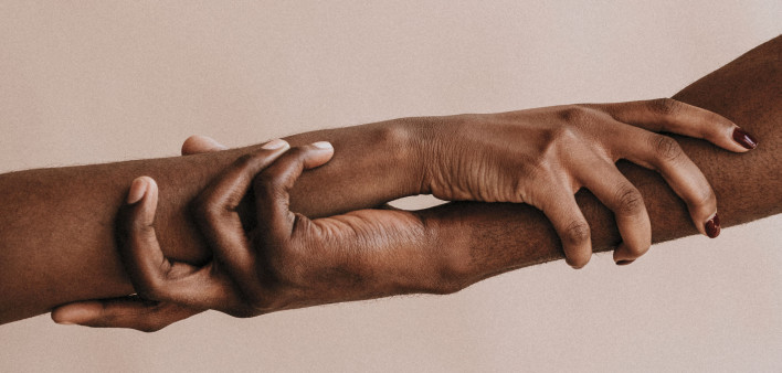 two hands holding each other black