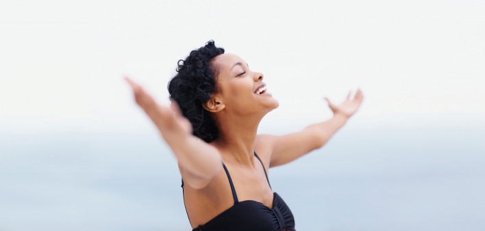 woman happy arms spread in joy