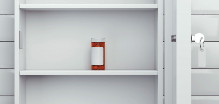pill bottle in empty medicine cabinet meds