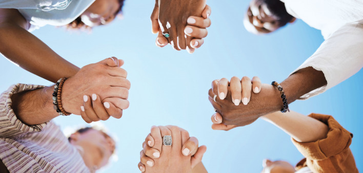 group of people holding hand to form a circle support