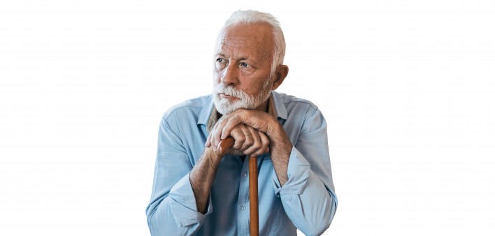 elderly man sitting leaning on his cane