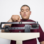 overweight hispanic teen on scale