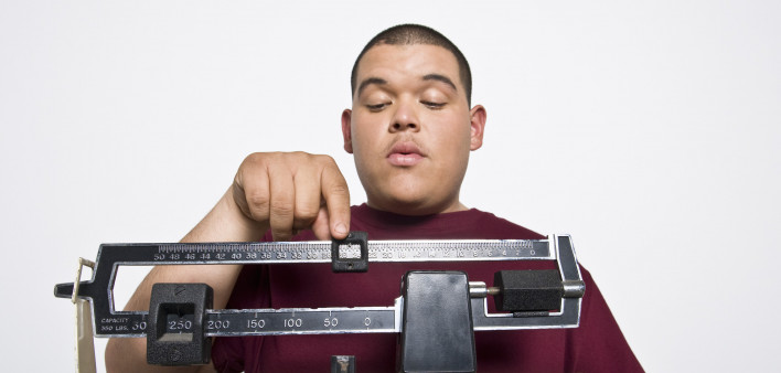 overweight hispanic teen on scale