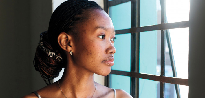 Black woman looking out window