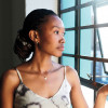 Black woman looking out window